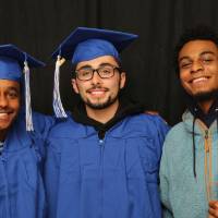 three men take GradFest photobooth picture